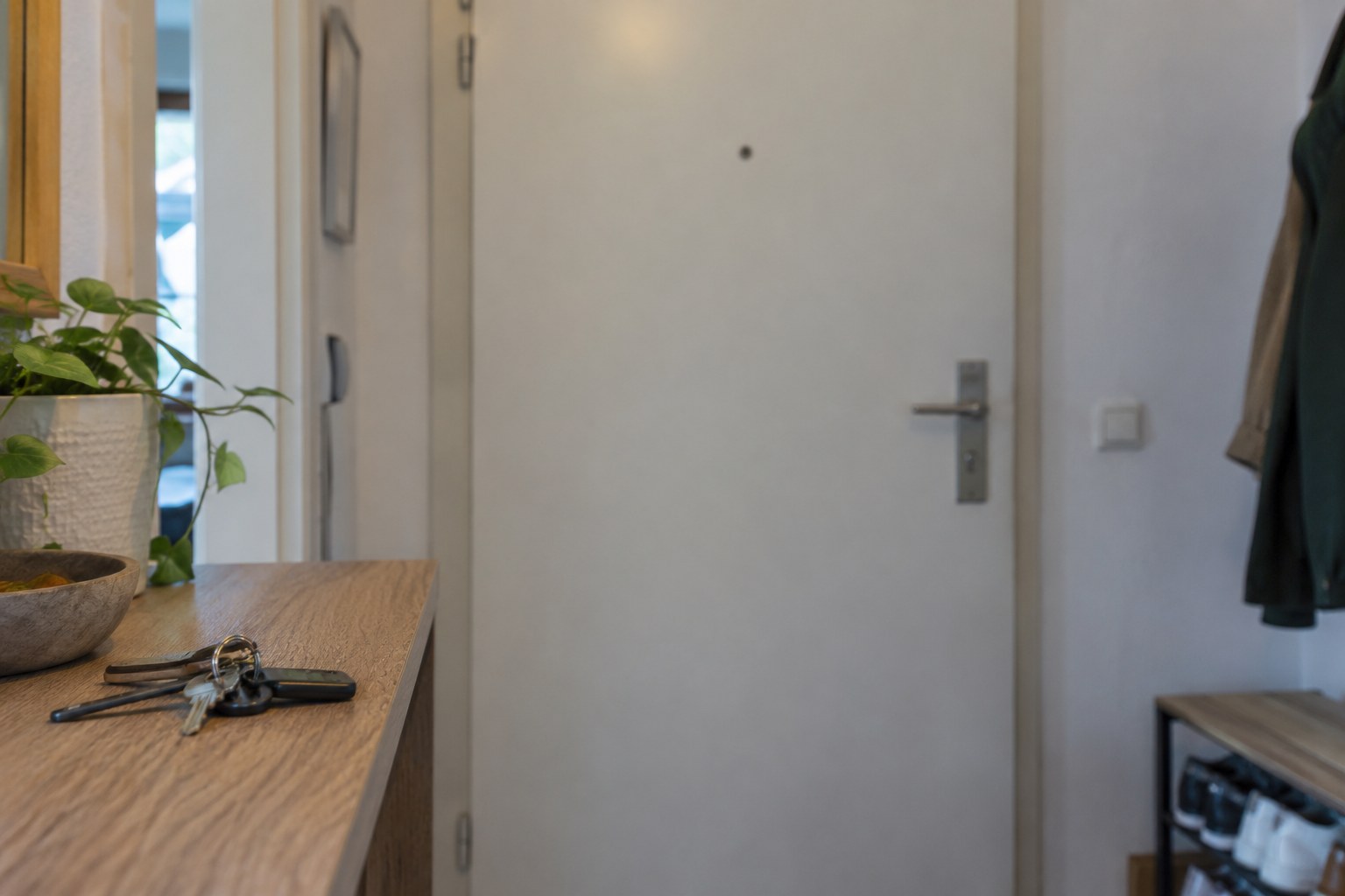 Wohnungstür und Schlüssel an einer Ablage.